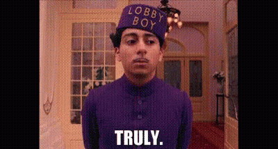 Man In Purple Suit And Hat Standing In Room GIF
