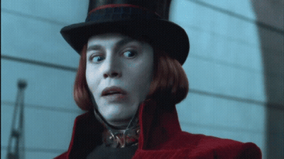 Man In Purple Suit And Top Hat Smiling Talking To Another Man GIF