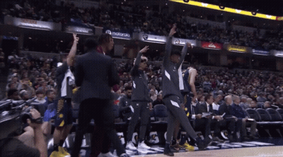 Man In Purple Suit Giving Peace Sign At Motorola Sign GIF