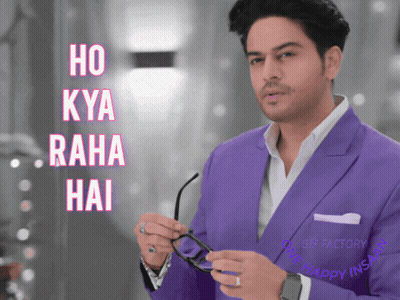 Man In Purple Suit Holding Glasses In Front Of Ho Kya Raha Hai Sign GIF