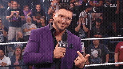 Man In Purple Suit Holding Microphone GIF