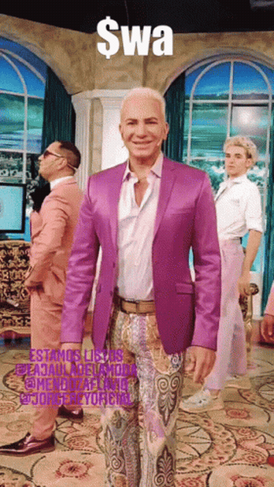 Man In Purple Suit Standing In Front Of Swa Sign GIF
