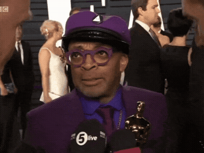 Man In Purple Suit Talking Into 5Live Microphone GIF