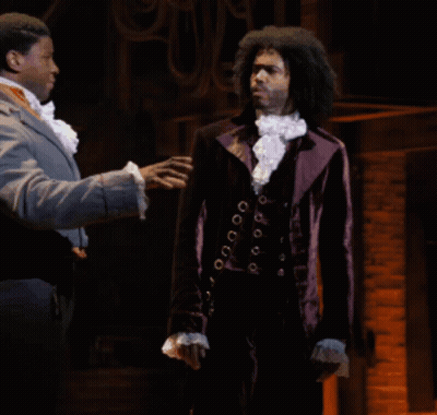 Man In Purple Suit Talking To Another Man GIF