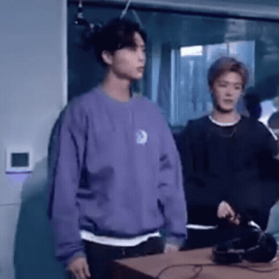 Man In Purple Sweater Next To Man In Black Shirt GIF