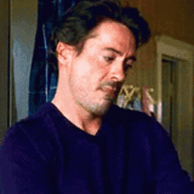 Man In Purple Sweater Sitting GIF