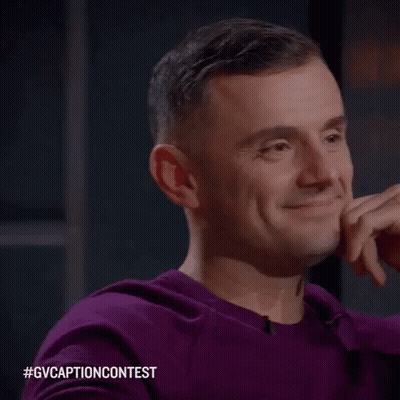 Man in Purple Sweater Smiling Hand to Chin