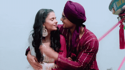 Man In Purple Turban Hugging Woman In Pink Dress GIF