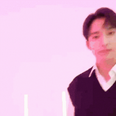 Man In Purple Vest And White Shirt In Front Of Pink Wall GIF