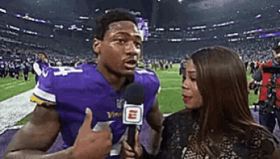 Man In Purple Vikings Jersey Interviewed By Woman GIF