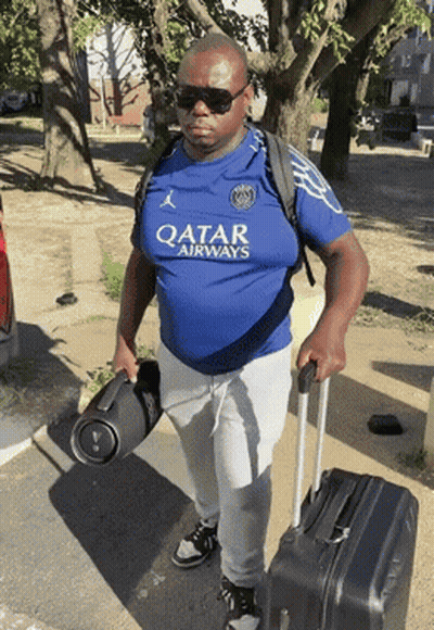 Man In Qatar Airways Shirt Carrying Suitcase GIF