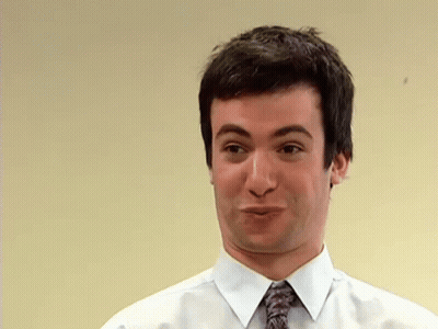 Man In Race Car Standing Next To Woman In Dress GIF