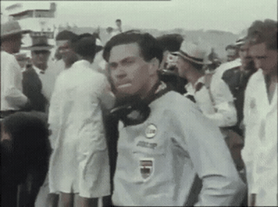 Man In Racing Shirt In Crowd GIF