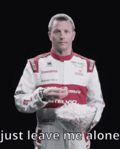 Man In Racing Suit Holding Popcorn GIF