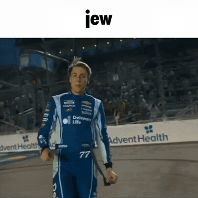 Man In Racing Suit Holding Stick GIF
