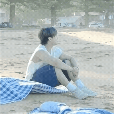 Man In Racing Suit Standing In Front Of Couch Saying Sit On It And Do Tricks GIF