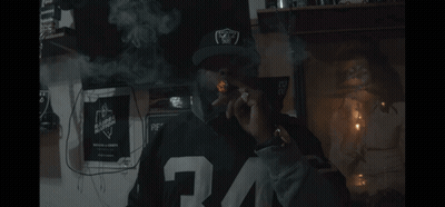 Man In Raiders Hat Smoking GIF