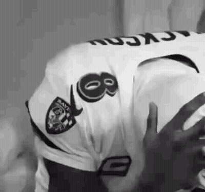 Man In Raiders Jersey Holding Football GIF
