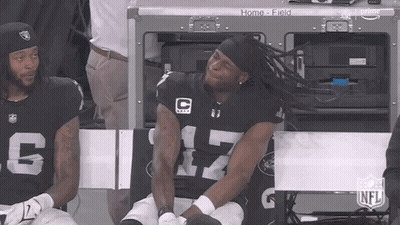 Man In Raiders Jersey Sitting On Bench GIF
