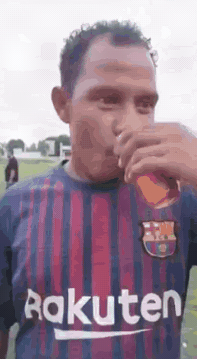 Man In Rakuten Jersey Drinking From Glass GIF