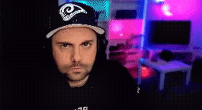 Man In Rams Hat Sitting In Front Of Television GIF