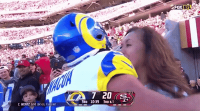 Man In Rams Jersey Kissing Woman GIF