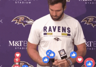 Man in Ravens T-Shirt in Front of Purple Backdrop