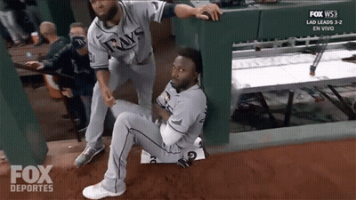 Man In Rays Jersey Being Helped By Another Man GIF