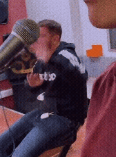 Man In RBSO Hoodie Talking Into Microphone GIF