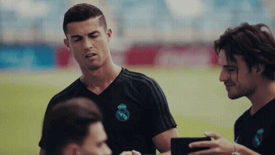 Man In Real Madrid Shirt Talking On Soccer Field GIF