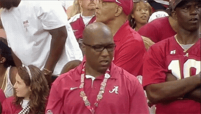 Man In Red Alabama Shirt Stands In Crowd GIF