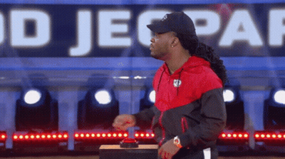 Man In Red And Black Jacket Pressing Jeopardy Button GIF