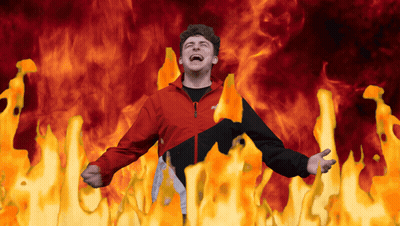 Man In Red And Black Jacket Surrounded By Fire GIF