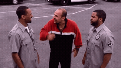 Man In Red And Black Jacket Talking To Guards GIF