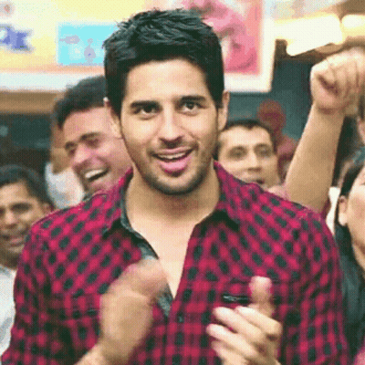 Man In Red And Black Plaid Shirt Clapping In Crowd GIF