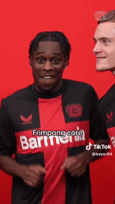Man In Red And Black Shirt Next To Man In Black Shirt GIF