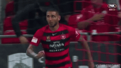 Man In Red And Black Soccer Jersey By Fence GIF
