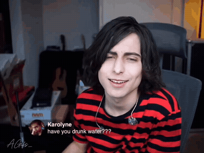 Man In Red And Black Striped Shirt Asking Karolyne If He Is Drunk GIF