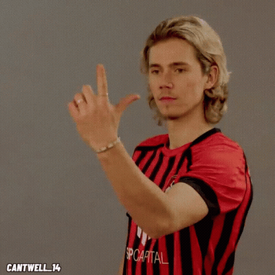 Man In Red And Black Striped Shirt With Capital GIF