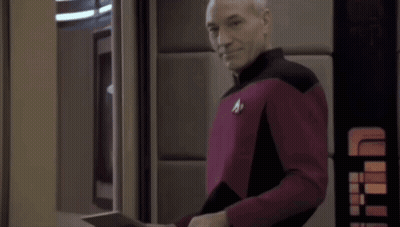 Man In Red And Black Uniform Holding Tablet GIF