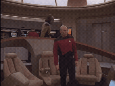 Man In Red And Black Uniform Standing In Room GIF