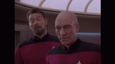 Man In Red And Black Uniform With Star Trek Badge GIF