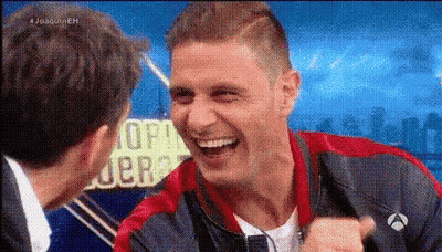 Man In Red And Blue Jacket Laughing With Another Man GIF