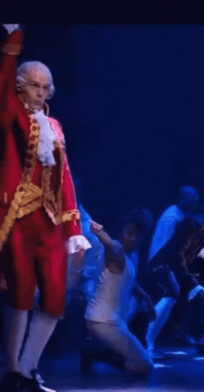 Man In Red And Gold Costume Dancing On Stage GIF