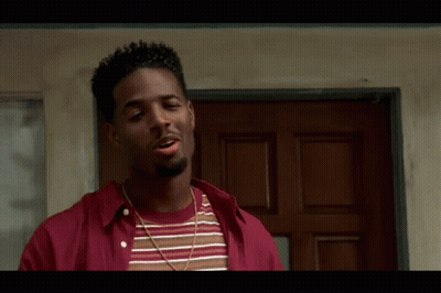 Man In Red And Striped Shirt Standing Before Door GIF