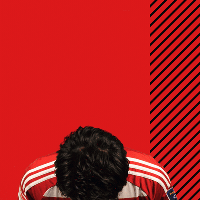 Man in Red and White Adidas Jersey With Letter C
