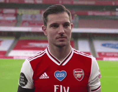 Man In Red And White Adidas Jersey With NHS Heart GIF