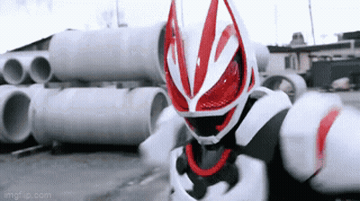 Man In Red And White Costume Standing In Front Of Pipes GIF