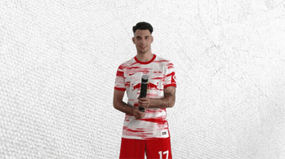 Man in Red and White Jersey With Bull