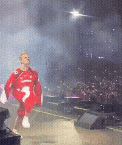 Man in Red and White Outfit Dancing on Stage